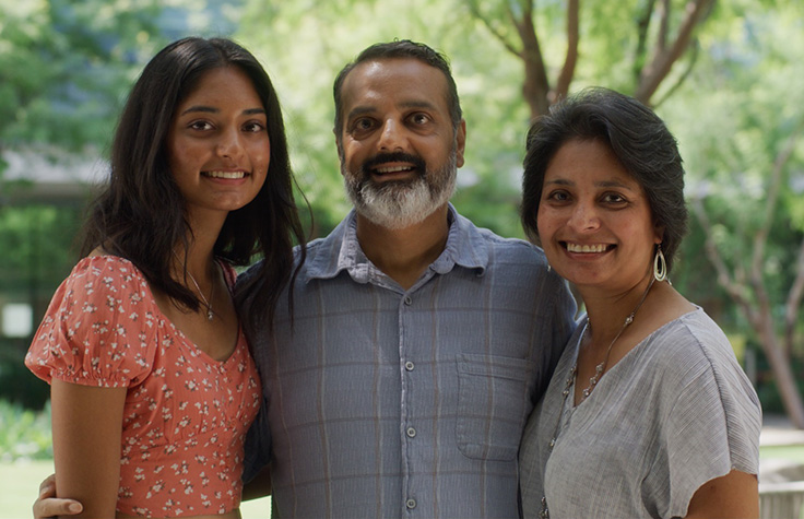 3 family members smiling