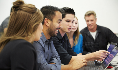 A team of employees gathered together working on a project.