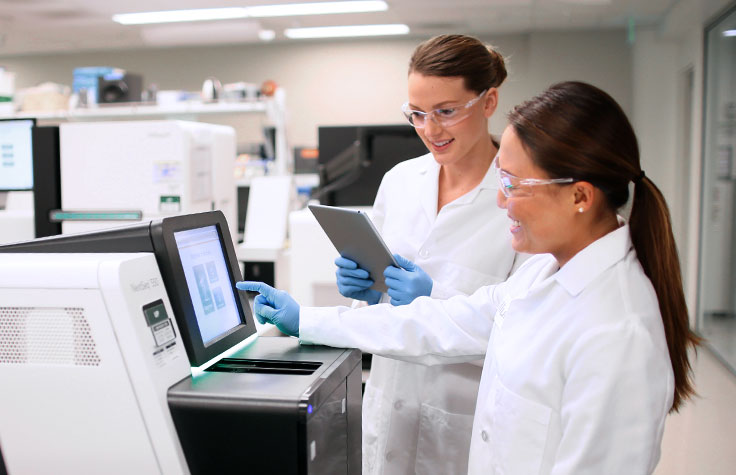 Scientists using a sequencer in their lab