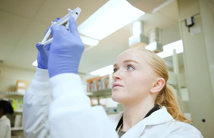 Lab technician reviewing array