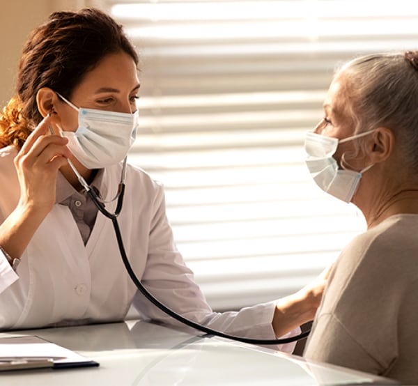 Doctor listening to patient's lungs.